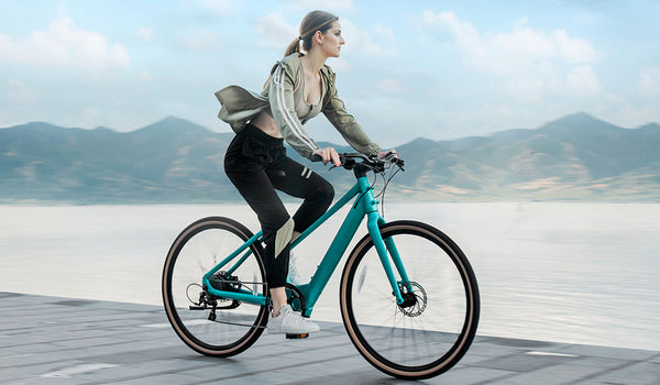Woman riding electric bike by the lake