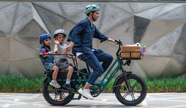 Man riding fiido t2 electric bicycle carrying two children