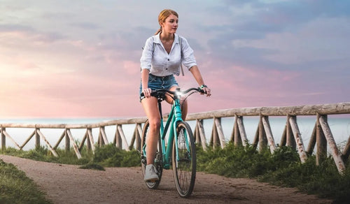 A woman is riding a Fiido C22 electric bike in the city.