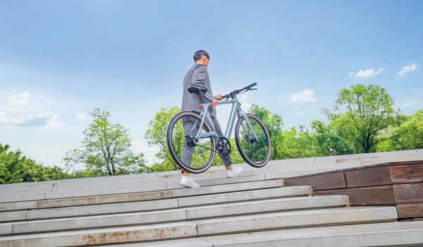 A man climbs the stairs with the Fiido Air with ease.