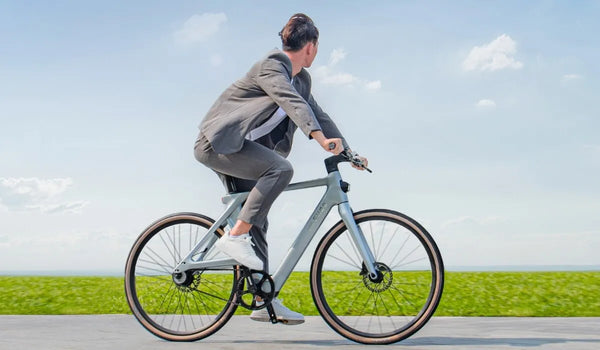 A man rides a Fiido Air electric bike on a road in the city