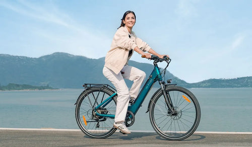 A woman walks by the lake on a Fiido C11 Pro electric bike