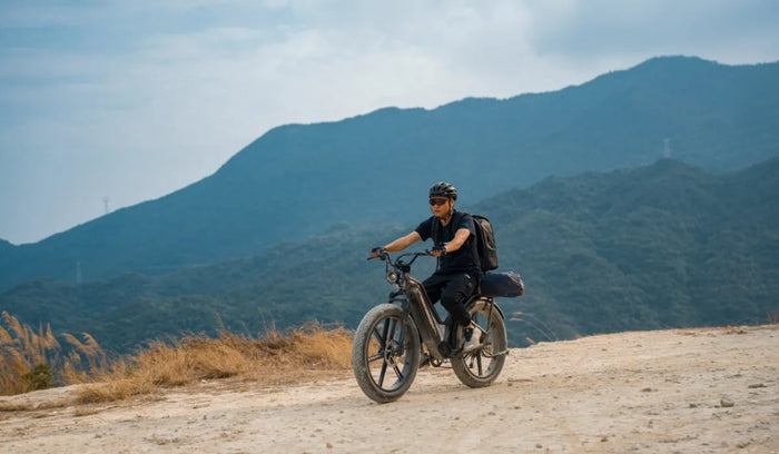 A man rides a Fiido Titan electric bike off-road