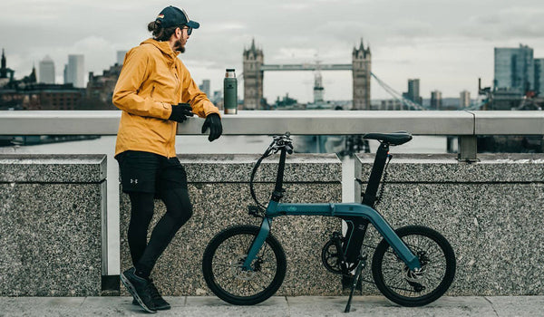 Man and Fiido D11 electric bike by the bridge