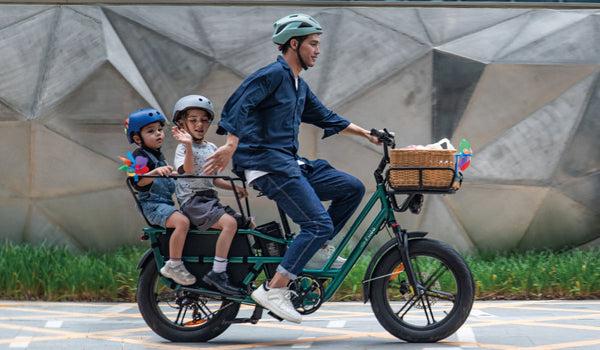 A man rides a Fiido T2 electric bike with two children 