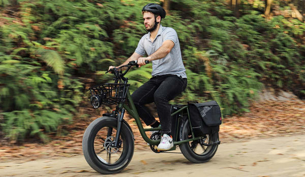 A man is riding downhill on a Fiido T1 e-bike