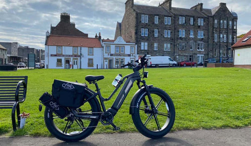 A Fiido Titan e-bike parked in a charming European town square, ready for an adventure.