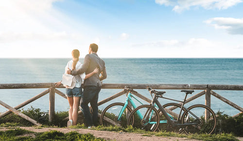 A group of couples riding Fiido C22 and Fiido C21 electric bicycles on the bridge