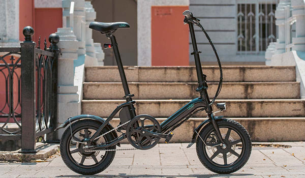 The Fiido D3 Pro is parked by a staircase, showing its compact design.