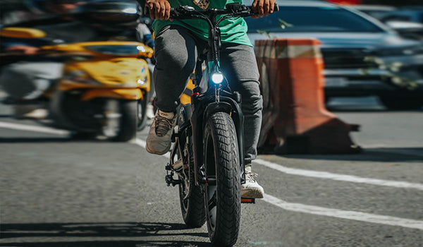 A man riding an M1 pro in the driveway.