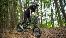 A cyclist is riding along a forest trail on a Fiido M1 Pro electric bike.