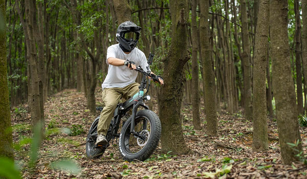 Man riding a Fiido M1pro electric bike in the woods for an adventure