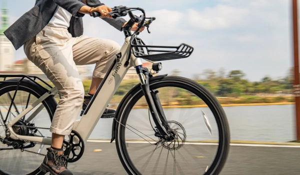 Woman riding a Fiido C11 electric bike by the lake.