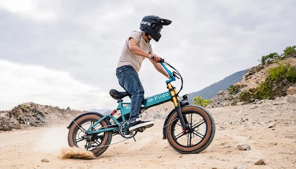 Man riding an upgraded Fiido M1 pro electric bike on the sand