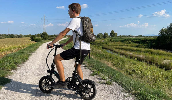  A rider enjoying the Fiido D3pro electric bike on a scenic country trail.