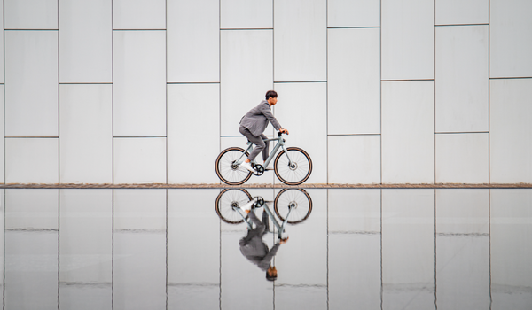 A man rides a Fiido Air over water-covered ground.