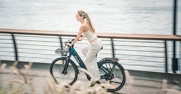 A woman is riding a Fiido C11 Pro urban lightweight electric bicycle on the road.