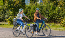 Two people are riding the Fiido C11 lightweight electric bike.