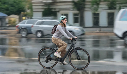 A woman is commuting on a Fiido C21 lightweight electric bike.