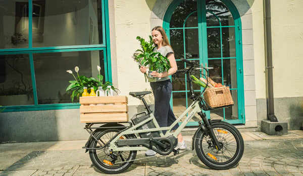 Woman riding a Fiido T3 cargo e-bike for grocery shopping