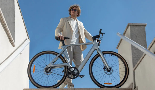 A man riding a Fiido Air carbon fiber electric bike in the city.