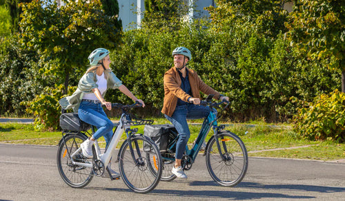 A couple is riding Fiido C11 Pro city electric bikes on the road.