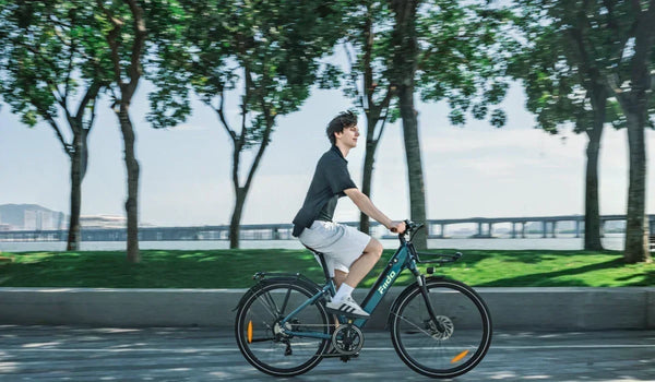 A man riding a Fiido lightweight city electric bike on a city street.
