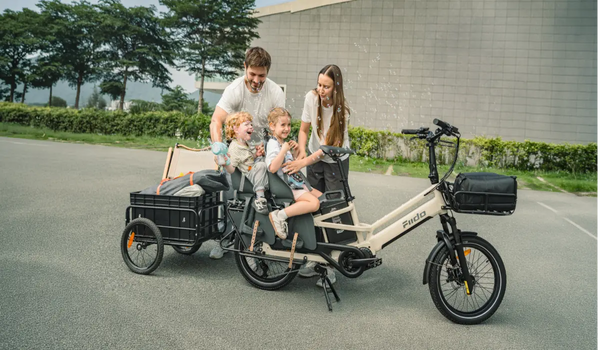 Family of four with a Fiido T3 Max electric cargo bike and rear cargo trailer