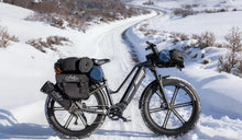 A Fiido Titan fat tire electric bike placed in the snow.