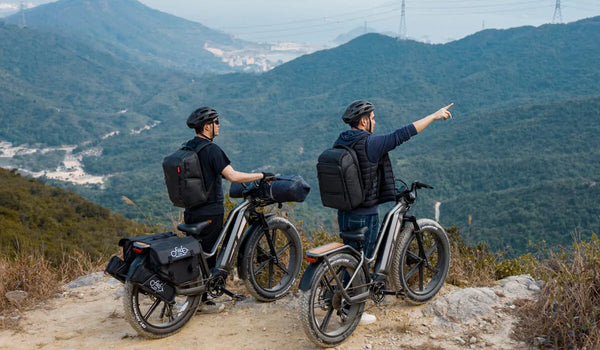 Two men are traveling long distances on a Fiido Titan e-bike with a three-battery setup.