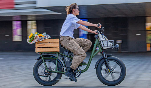 A cyclist speeds through an urban area on her Fiido T1Pro