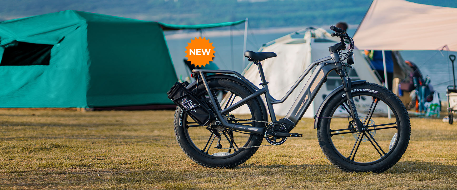 A Fiido Titan electric bike parked next to a tent - pc