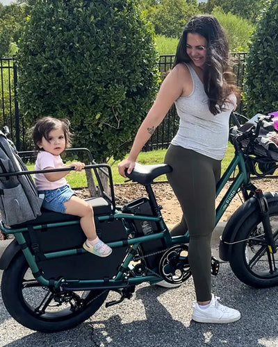User Duygu YILDIRIM rides a Fiido T2 electric bike, taking a child out for a ride.
