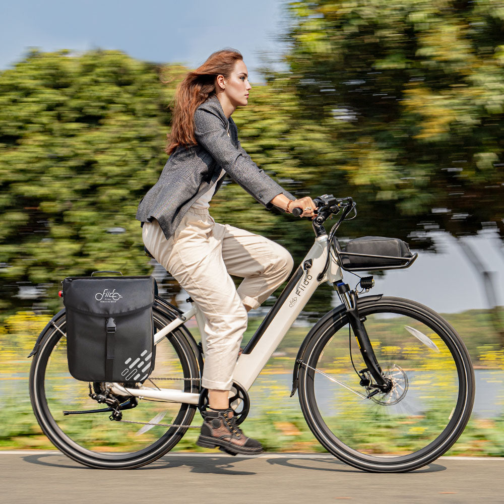Woman rides Fiido C11 city E-bike with bag and front basket