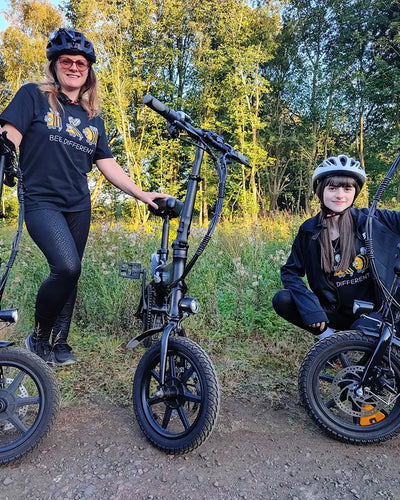 User BitzyBobzy and her sister ride a Fiido D3 Pro on a country road.