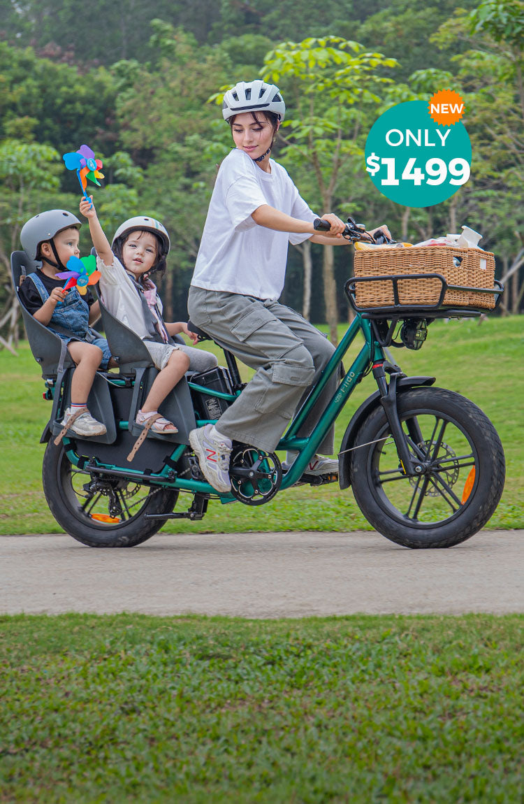 A woman rides a Fiido T2 electric bike with two kids, who are holding pinwheels - m