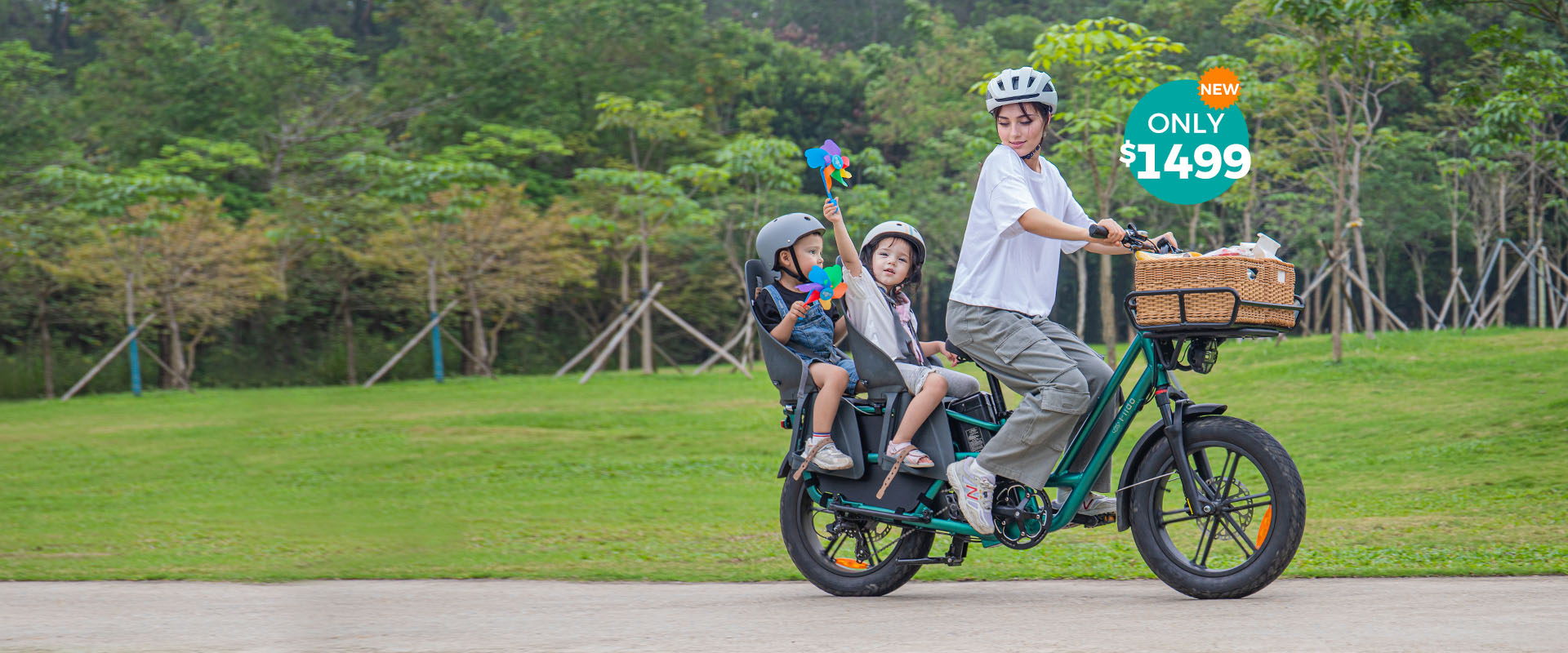 A woman rides a Fiido T2 electric bike with two kids, who are holding pinwheels - pc