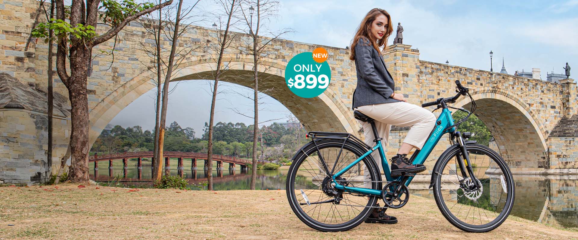 A woman rides a Fiido C11 electric bike by the river under a bridge - pc